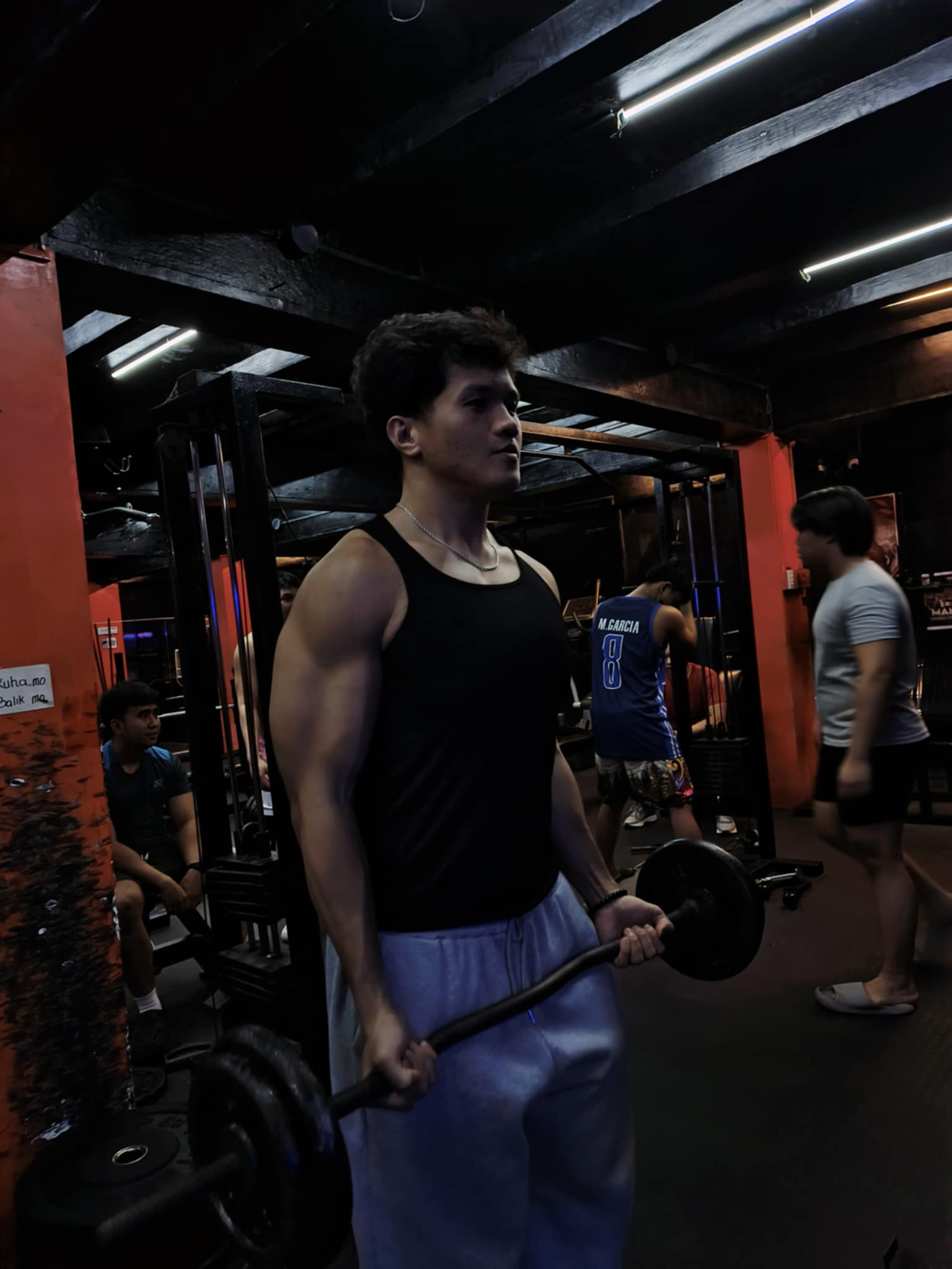 Two guys flexing in black tanks